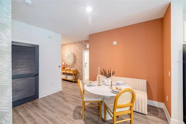 a view of a dining room with furniture and wooden floor