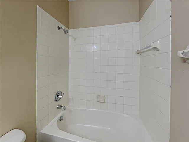 a bathroom with a bathtub and a toilet