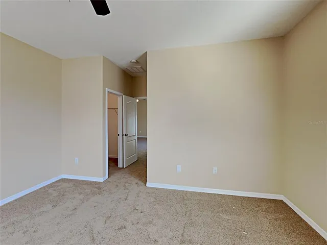 an empty room with closet and windows