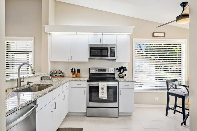 a kitchen with a stove a sink and a microwave