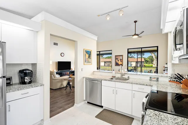 a kitchen with a sink stove and cabinets