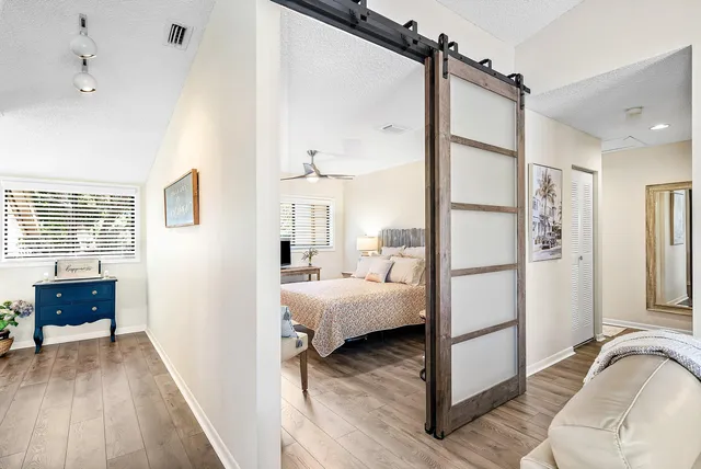 a view of bedroom with a bed and wooden floor