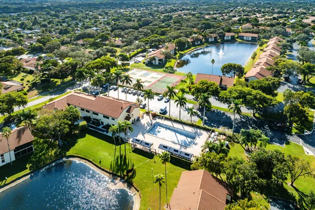 an aerial view of residential houses with outdoor space and swimming pool