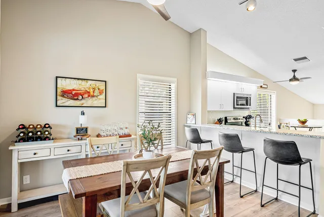 a living room with stainless steel appliances kitchen island granite countertop furniture and a view of kitchen