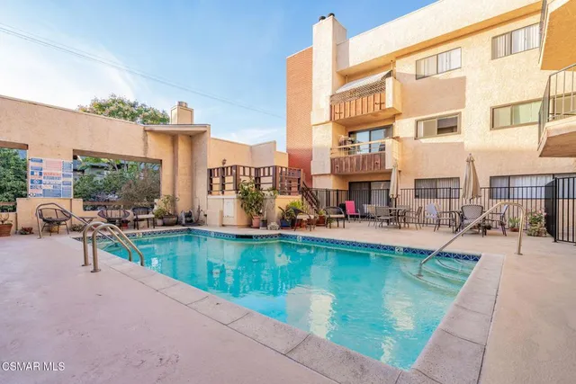 a view of a patio with a table and chairs