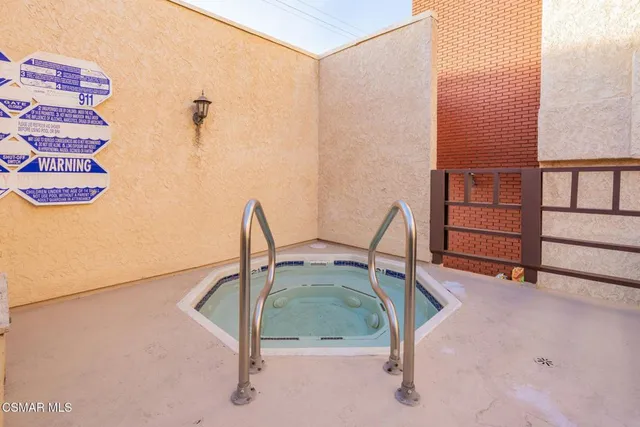 a view of a patio with a table and chairs