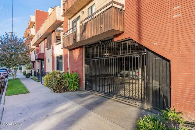 a front view of a building with a garden