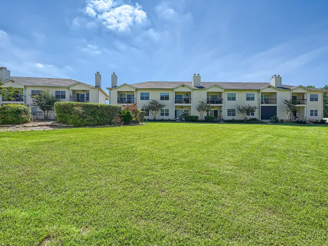 a view of a house with a yard and plants