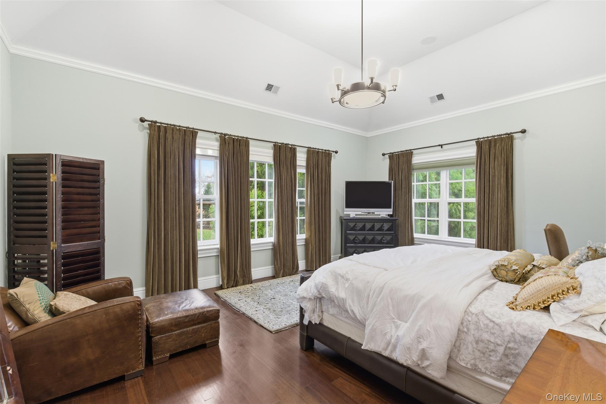 35 Chicken Valley Road Glen Head, NY 11545 - Photo 22 of 47 a bedroom with a large bed couch and windows