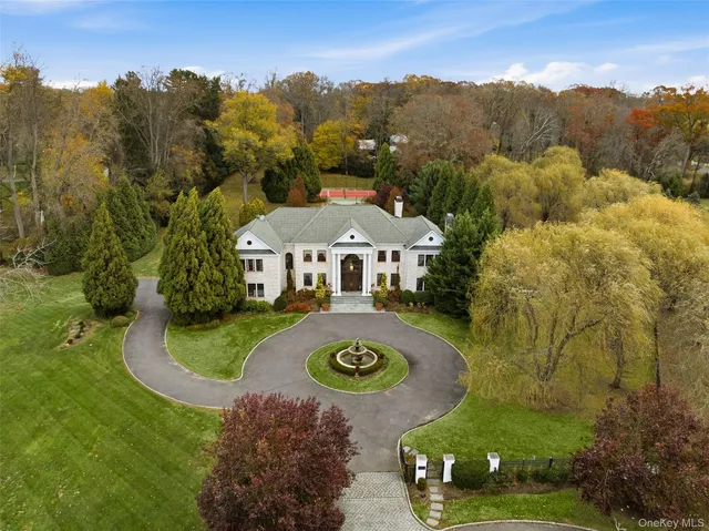an aerial view of a house with yard swimming pool and mountains