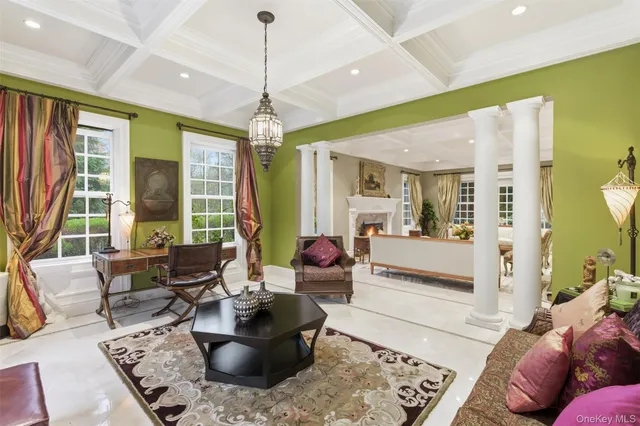a living room with furniture and a chandelier