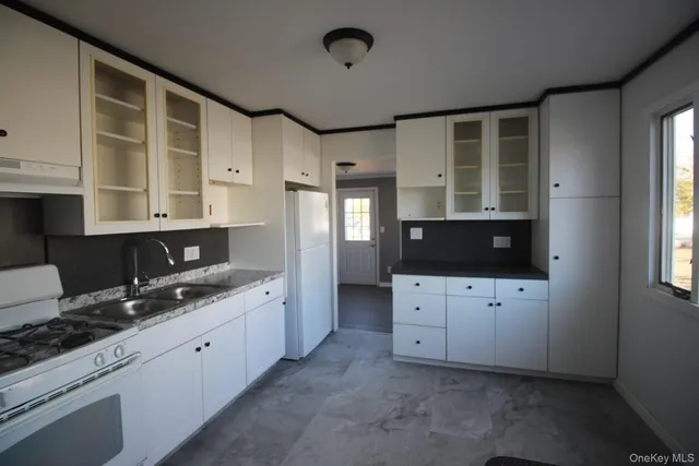 a view of cabinets a flat screen tv and a window