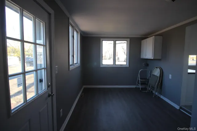 a view of a room with wooden floor and a window