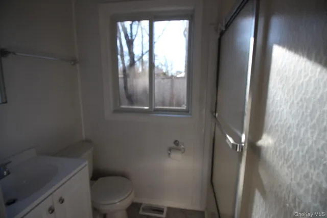 a bathroom with a toilet and a sink