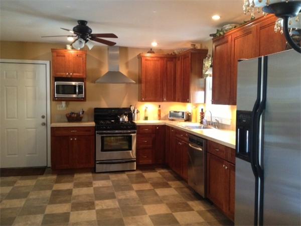 15 Joseph Street Acushnet, MA 02743 - Photo 4 of 22 a kitchen with stainless steel appliances granite countertop a stove a refrigerator and a sink