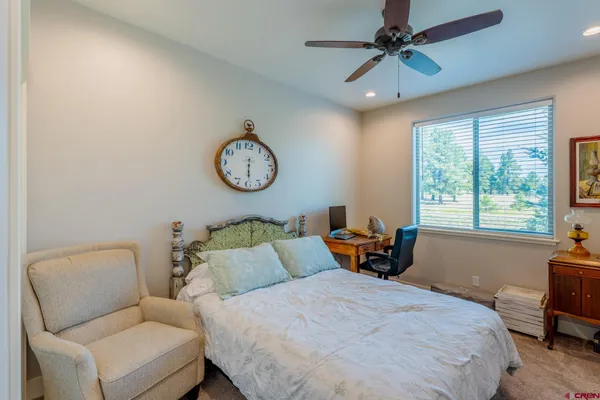 a bedroom with bed and a large window