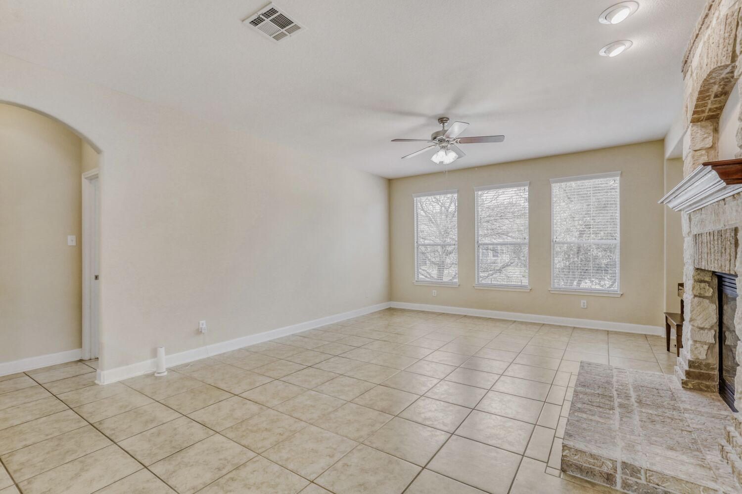 24 Stone Terrace Drive Austin, TX 78734 - Photo 12 of 32 an empty room with windows and fan