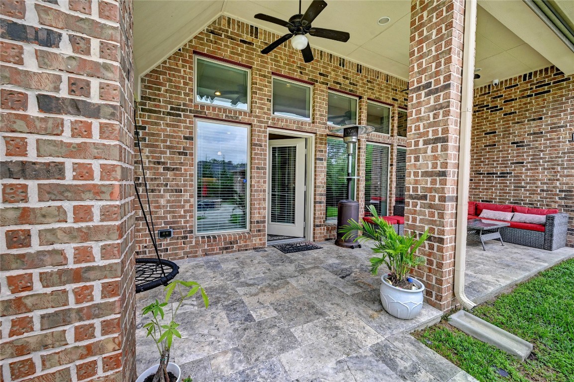 335 Fox Trail Road Montgomery, TX 77316 - Photo 34 of 47 The covered brick patio comes complete with plenty of seating , all the while providing seamless indoor-outdoor flow to the living and breakfast area.