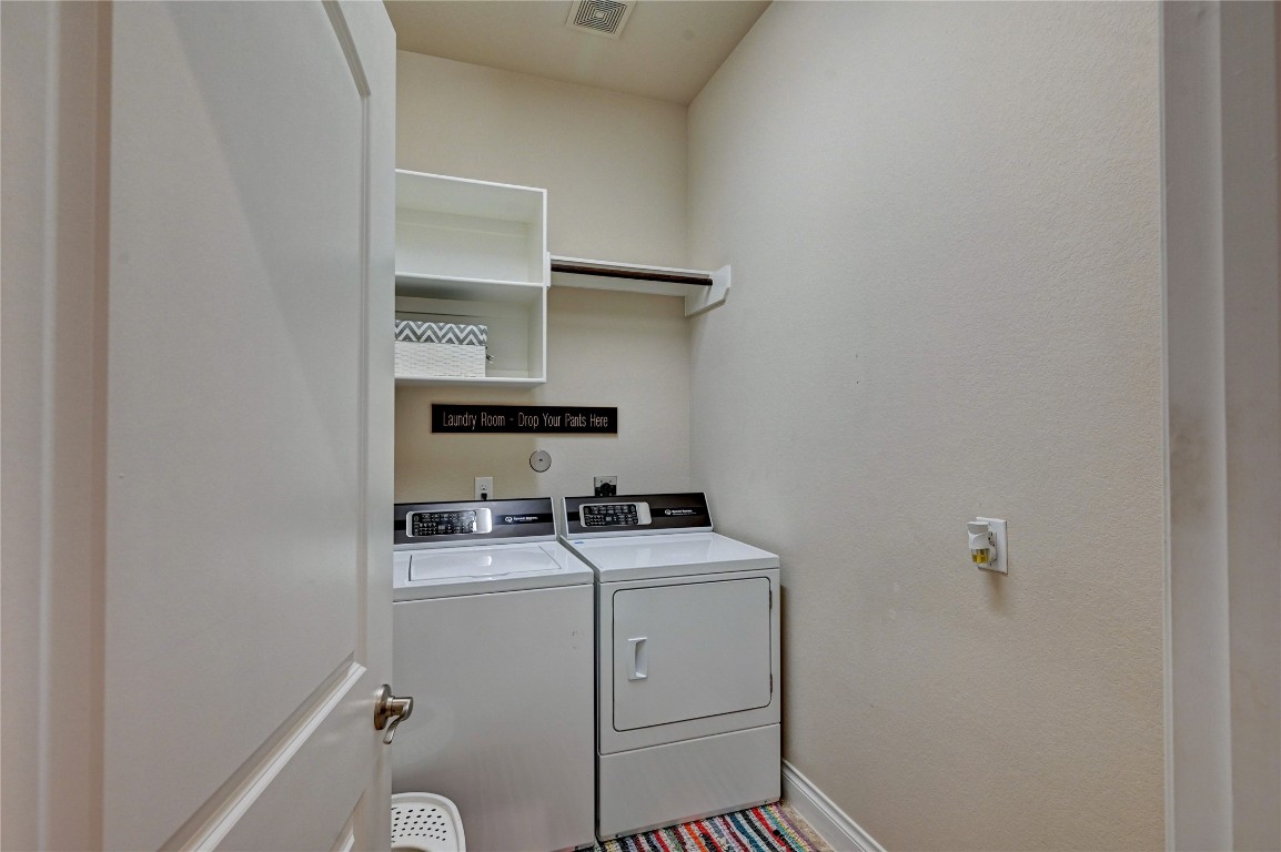 335 Fox Trail Road Montgomery, TX 77316 - Photo 38 of 47 Compact laundry room with washer and dryer, and shelving for storage.