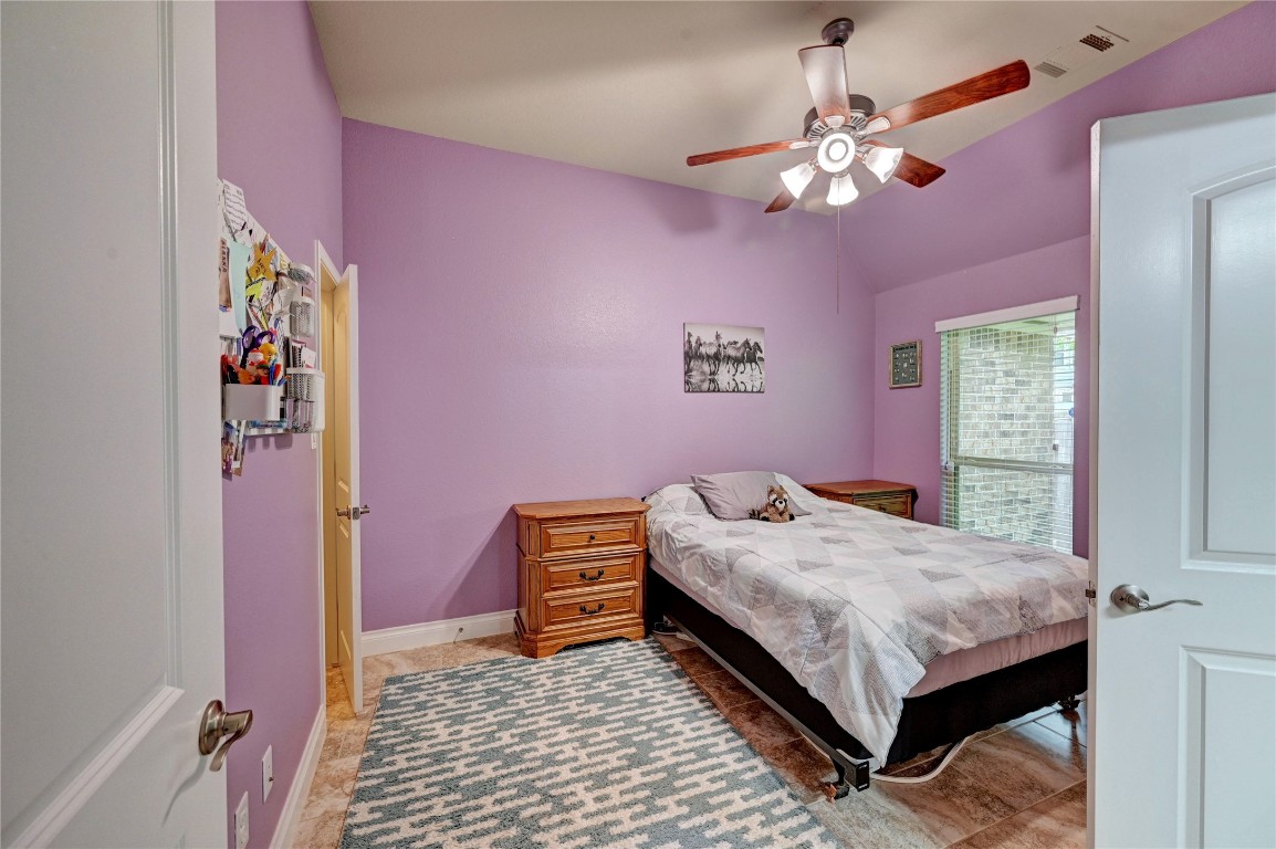 335 Fox Trail Road Montgomery, TX 77316 - Photo 39 of 47 Secondary bedroom , tile flooring, and a ceiling fan. It features a large window for natural light. Perfect for a comfortable and inviting personal space.