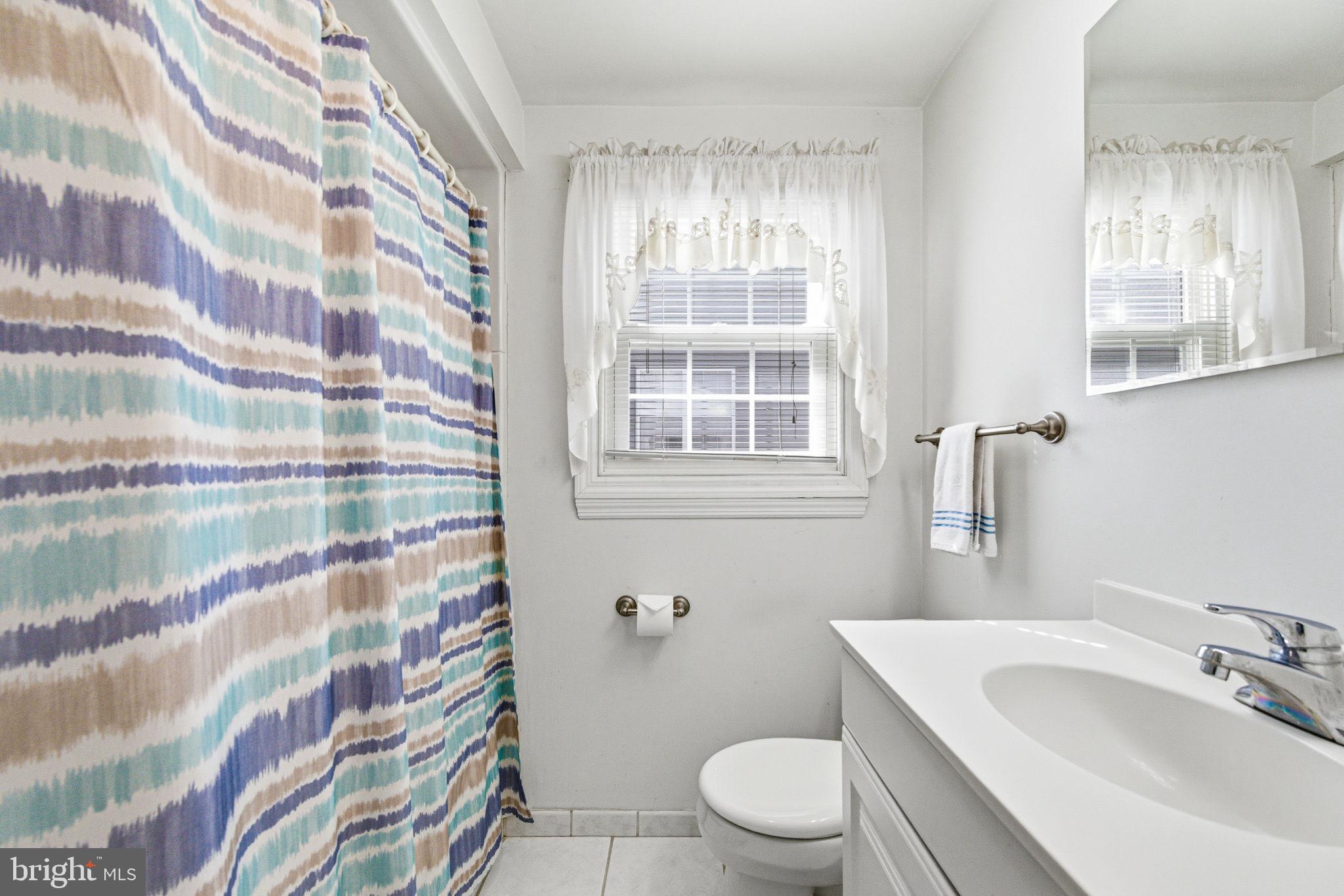 247 Orchard Road Springfield, PA 19064 - Photo 15 of 30 a bathroom with a sink toilet and shower curtain
