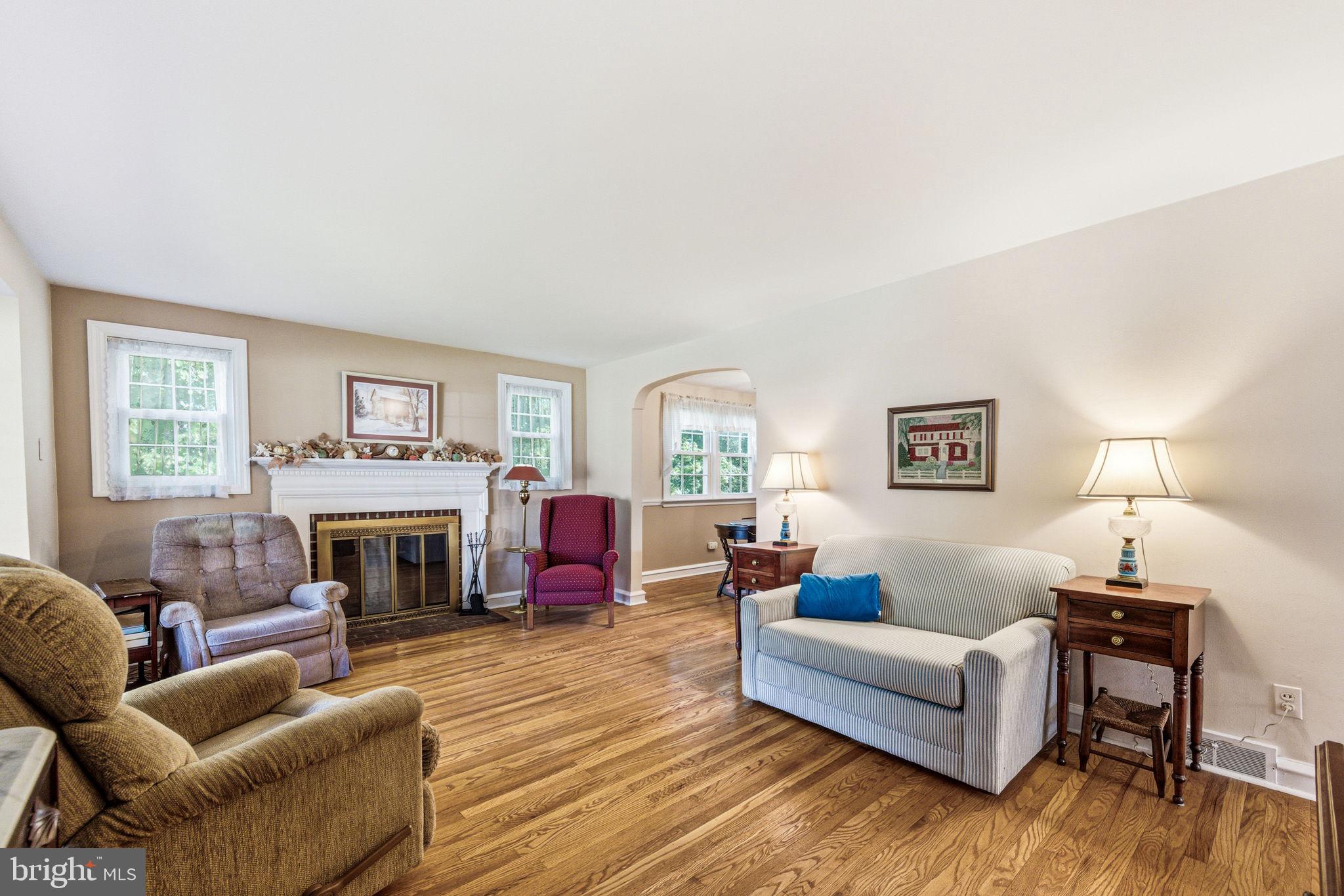 247 Orchard Road Springfield, PA 19064 - Photo 5 of 30 a living room with furniture flat screen tv and a fireplace