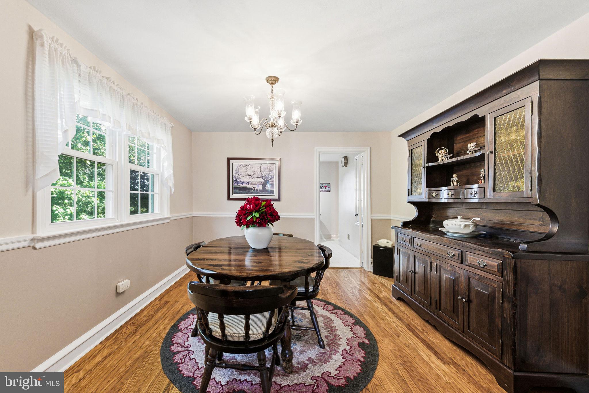 247 Orchard Road Springfield, PA 19064 - Photo 9 of 30 a view of a dining room with furniture a chandelier and wooden floor
