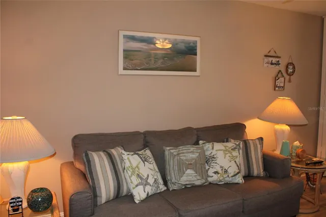 a living room with furniture and a lamp