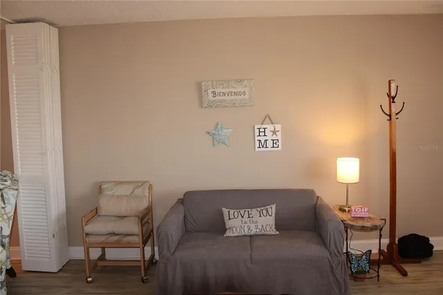a living room with furniture and a lamp