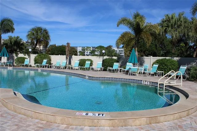a view of a swimming pool with a lounge chairs