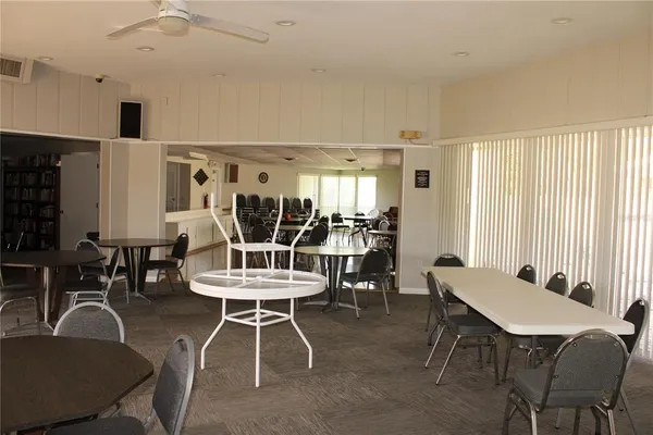a living room with furniture a rug and a book shelf