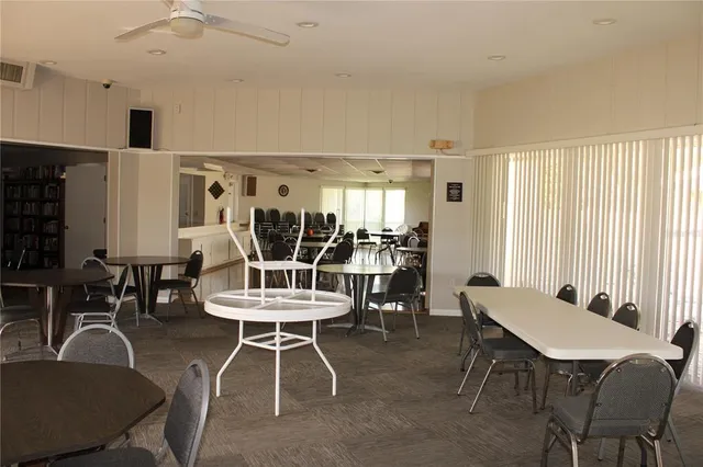 a living room with furniture a rug and a book shelf