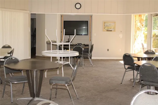a front view of a house with a yard and potted plants