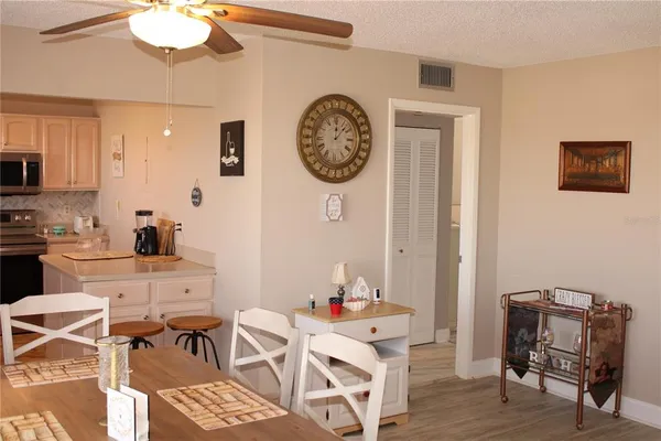a living room with furniture a chandelier and a window