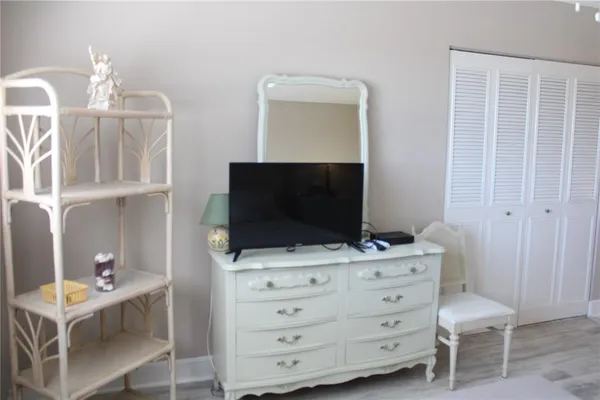 a bedroom with a bed and a chair