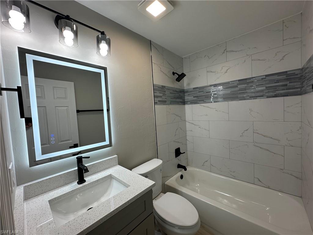 9165 Seville Road Fort Myers, FL 33967 - Photo 11 of 19 a bathroom with a sink a toilet and shower