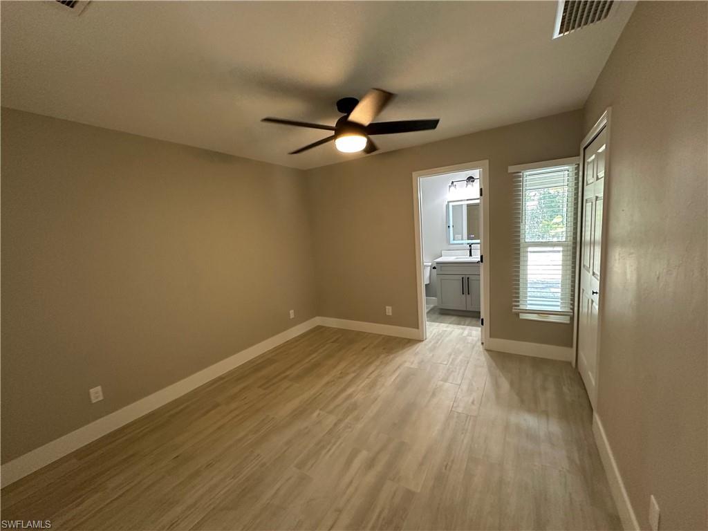 9165 Seville Road Fort Myers, FL 33967 - Photo 12 of 19 a view of empty room with wooden floor and fan