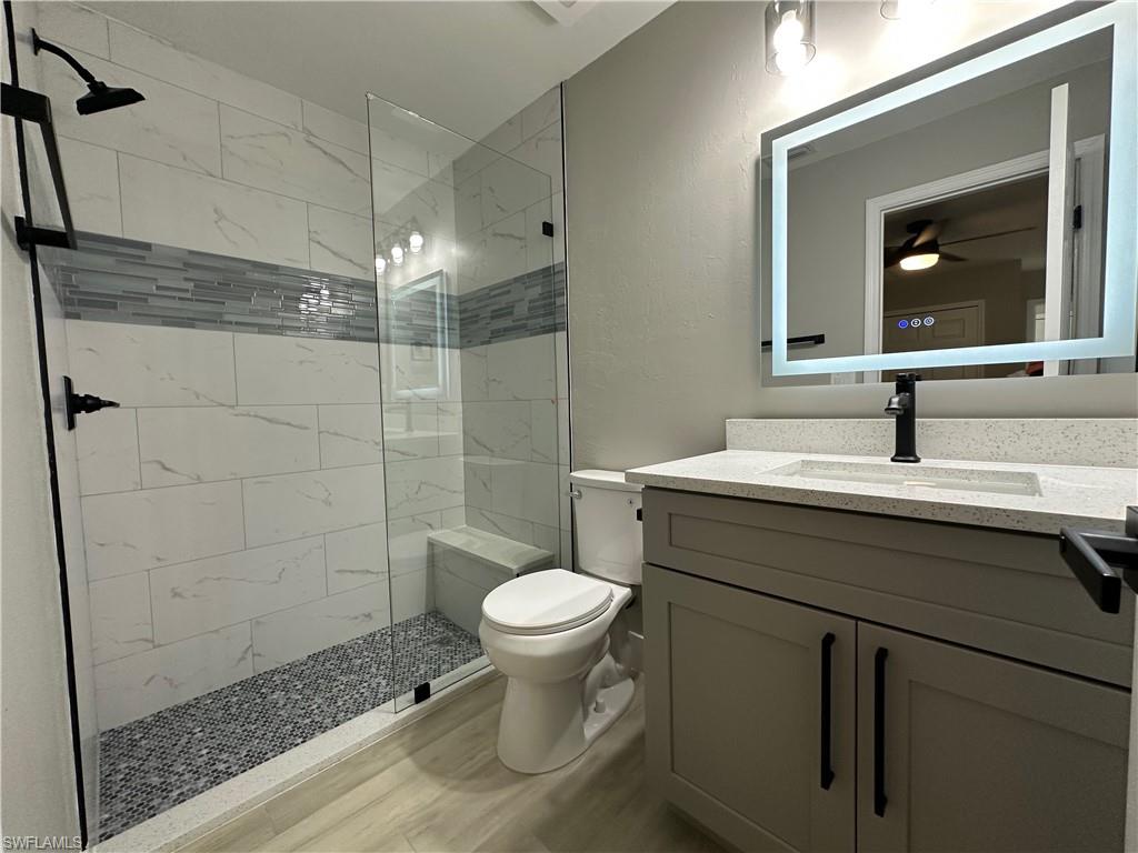 9165 Seville Road Fort Myers, FL 33967 - Photo 14 of 19 a bathroom with a sink toilet and shower