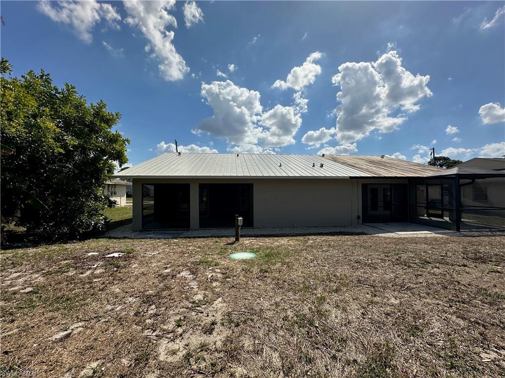 9165 Seville Road Fort Myers, FL 33967 - Photo 18 of 19 a front view of a house with a yard and garage