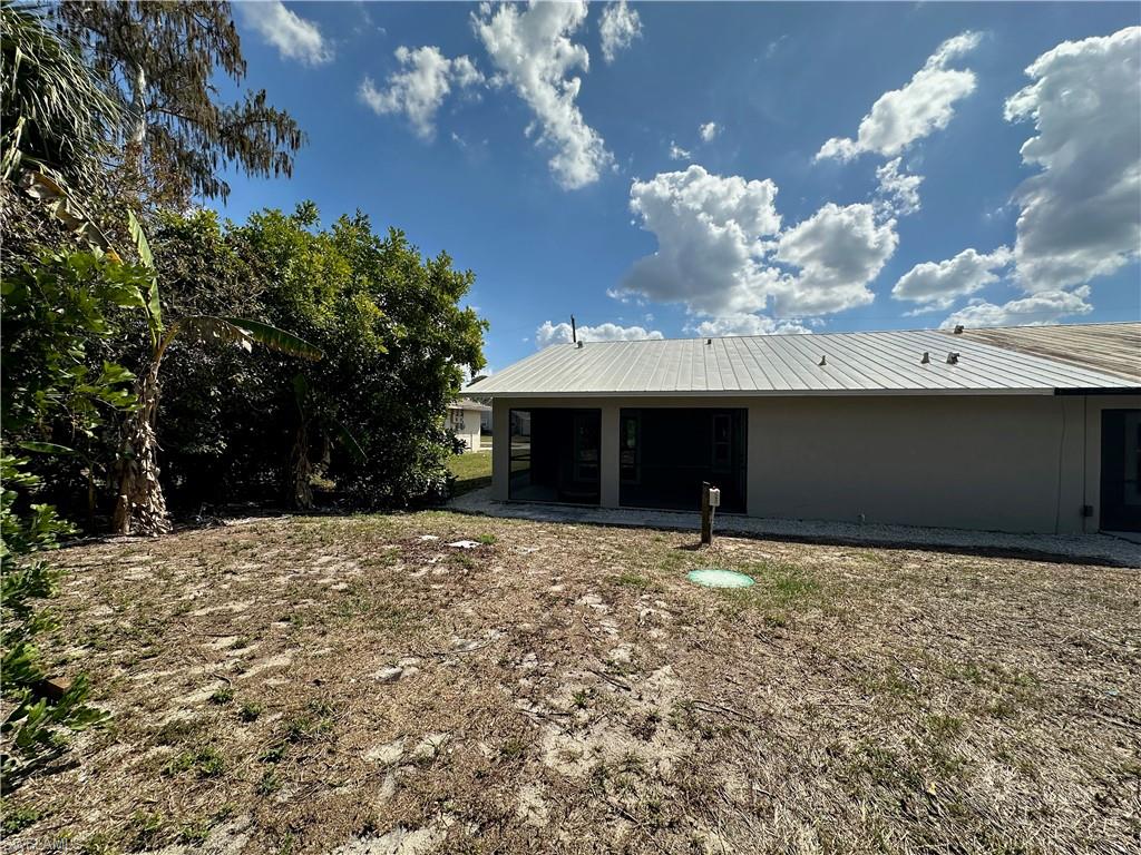 9165 Seville Road Fort Myers, FL 33967 - Photo 19 of 19 a front view of a house with a yard and garage