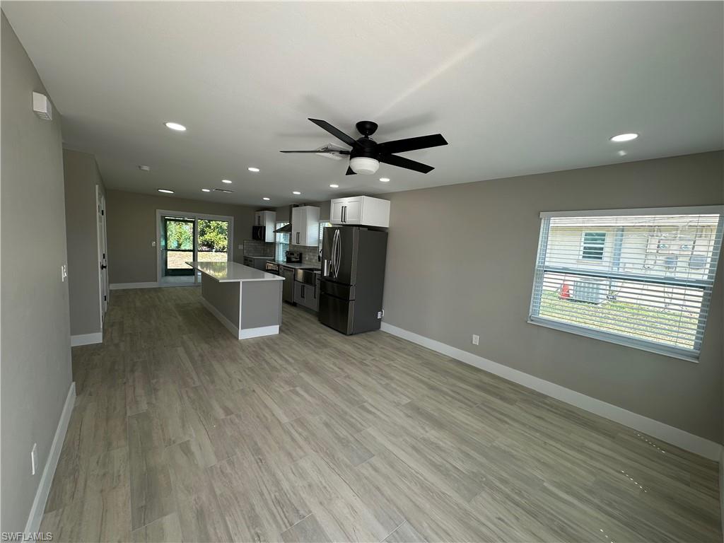 9165 Seville Road Fort Myers, FL 33967 - Photo 2 of 19 a view of a livingroom with a kitchen and wooden floor