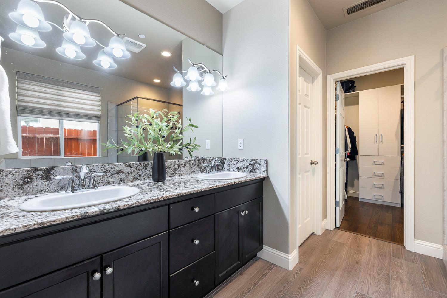 3293 Soledad Avenue Clovis, CA 93619 - Photo 18 of 37 a bathroom with a double vanity sink and a mirror