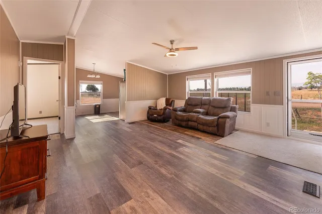 a living room with furniture window and wooden floor