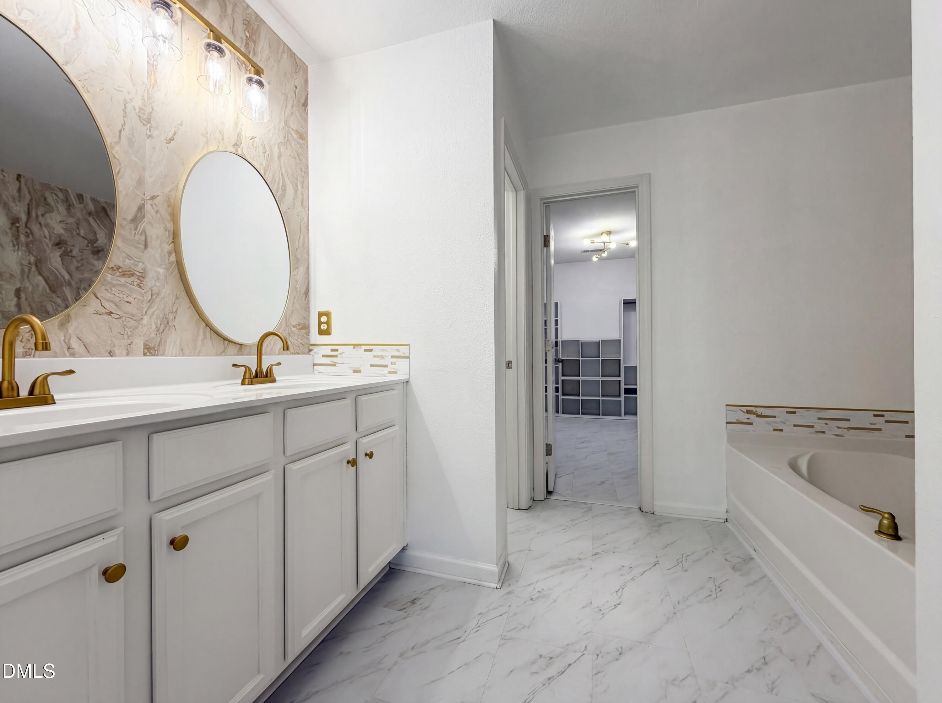 574 Botanical Court Bunnlevel, NC 28323 - Photo 17 of 20 a spacious bathroom with a double vanity sink and a mirror