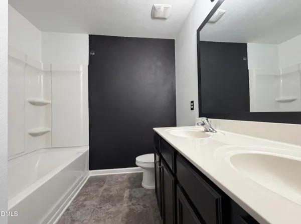 a bathroom with a sink a mirror and a bathtub
