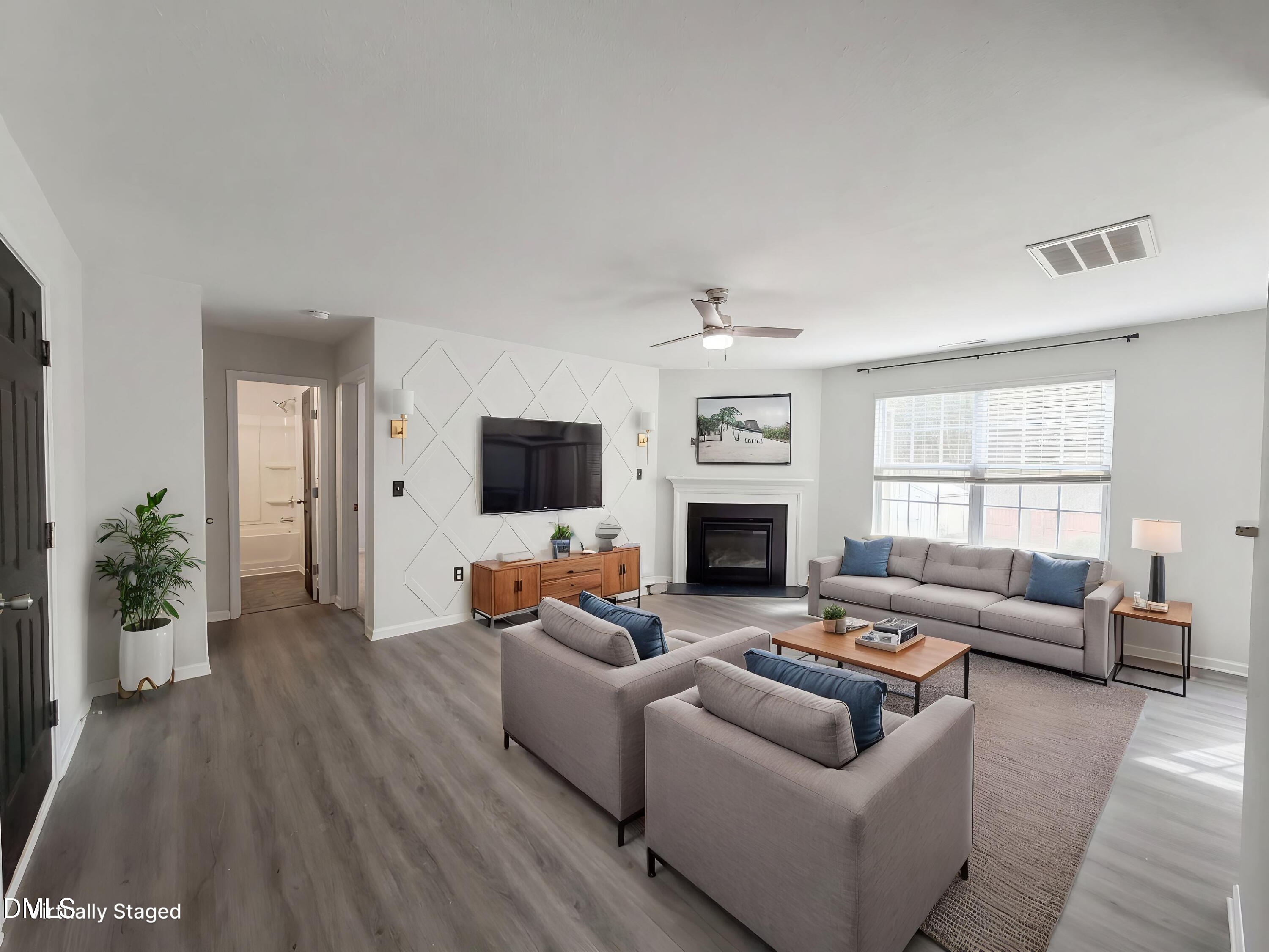 574 Botanical Court Bunnlevel, NC 28323 - Photo 2 of 20 a living room with furniture a flat screen tv and a fireplace