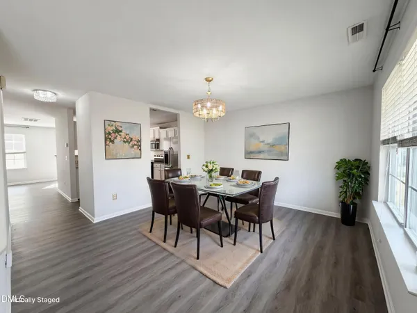 a view of a dining room with furniture window and wooden floor