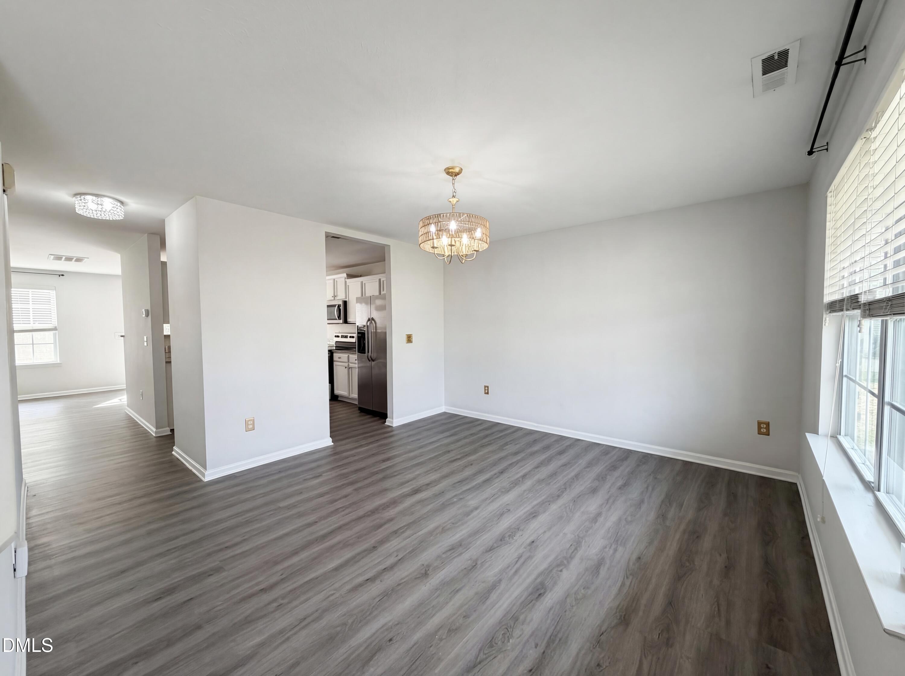 574 Botanical Court Bunnlevel, NC 28323 - Photo 9 of 20 an empty room with wooden floor and windows