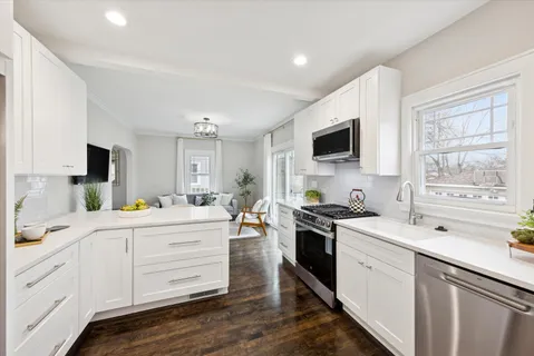 a kitchen with a stove a sink and a microwave