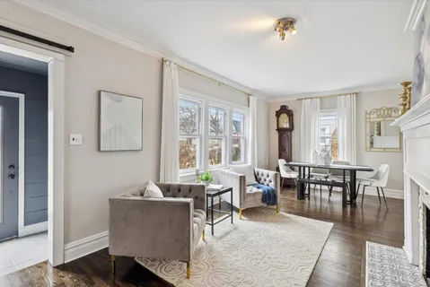 a living room with furniture a window and a dining table